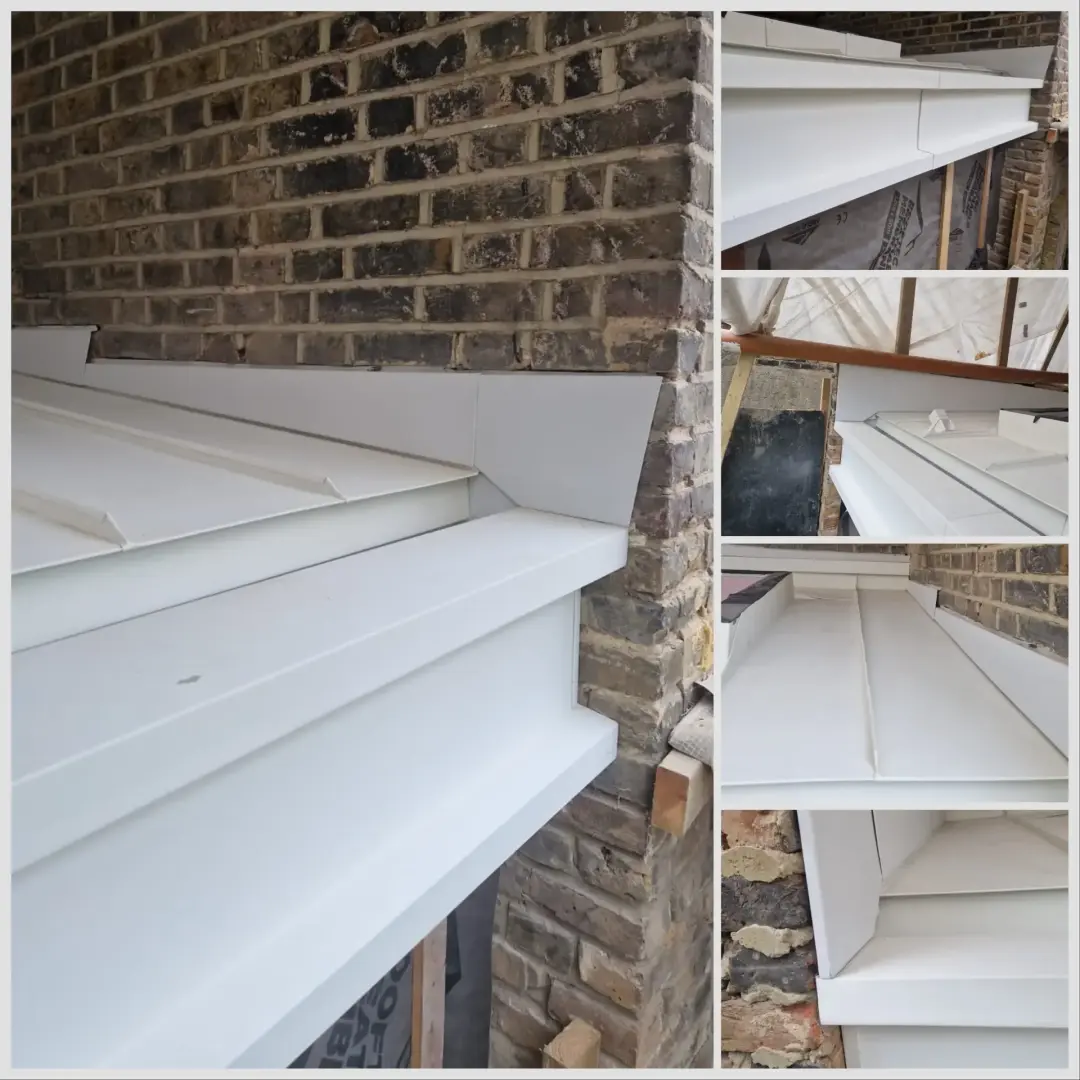 White folded metal flashings and cappings on a brick wall in Putney